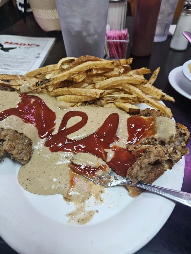 Chicken fried steak topped with cream gravy and hand-cut fries at Mary's Cafe in Strawn, Texas