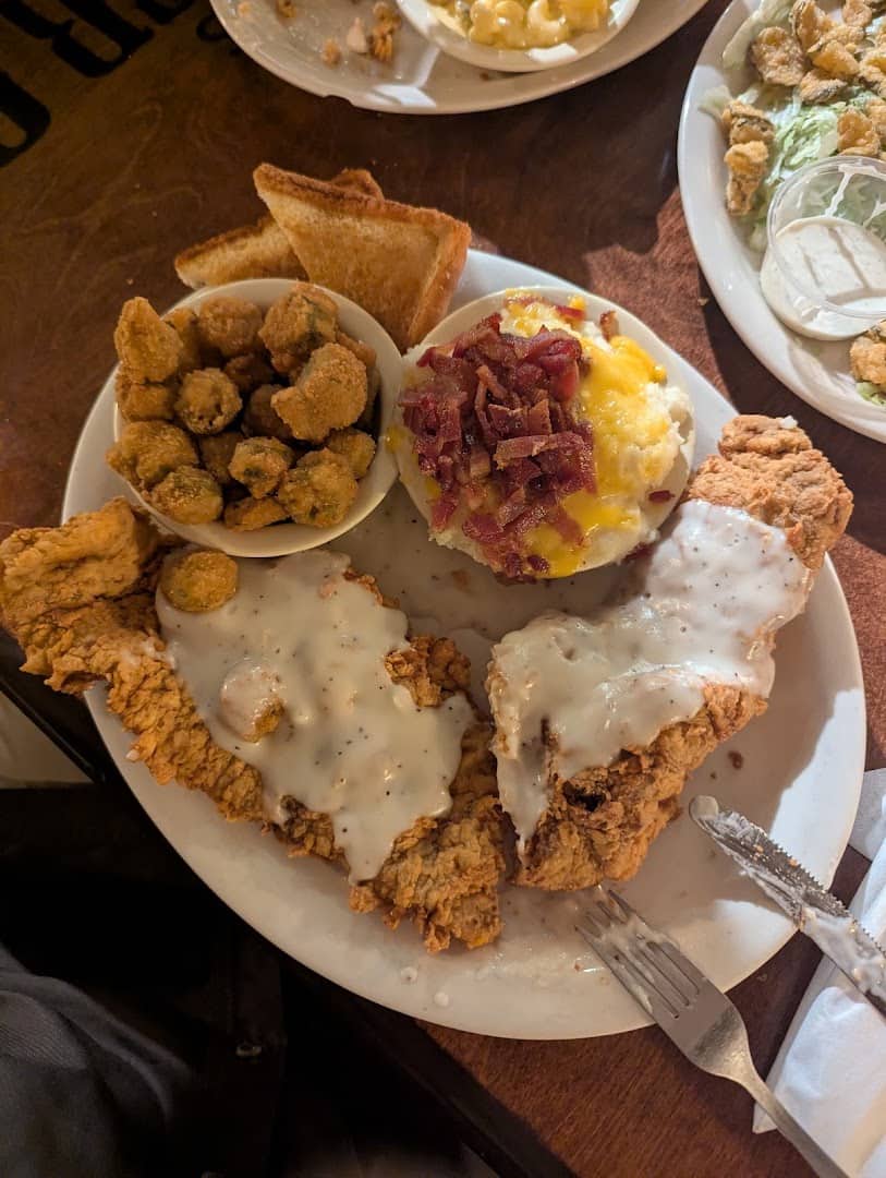 Chicken fried steak with cream gravy, fried okra and a loaded baked potato at Richter's Antler Cafe in Spring Branch