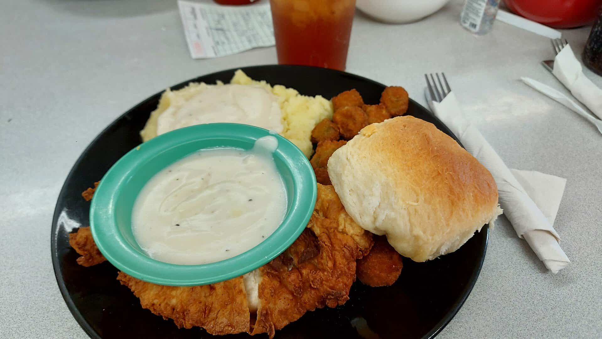 Chicken fried steak plate with mashed potatoes, fried okra and a roll at Whistle Stop Cafe in Decatur, Texas
