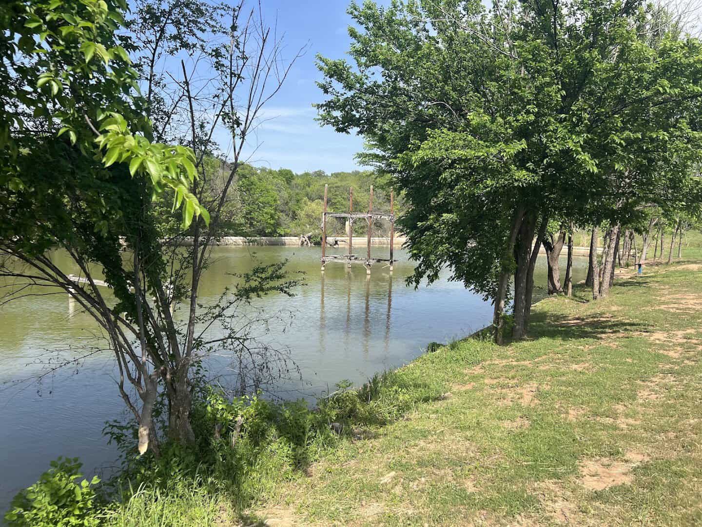 The old concrete swimming pool at Cisco, now a green pond with its diving platform still standing