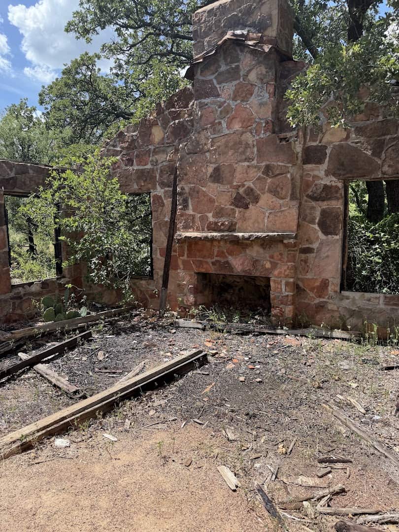 Inside the stone ruins of an old zoo building with a fireplace at the Old Zoo Nature Trails in Cisco, Texas