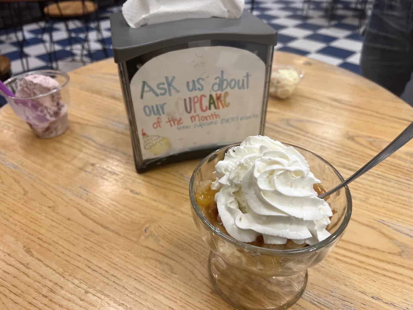 Classic sundae topped with whipped cream in a glass dish at Beth Marie's in Denton