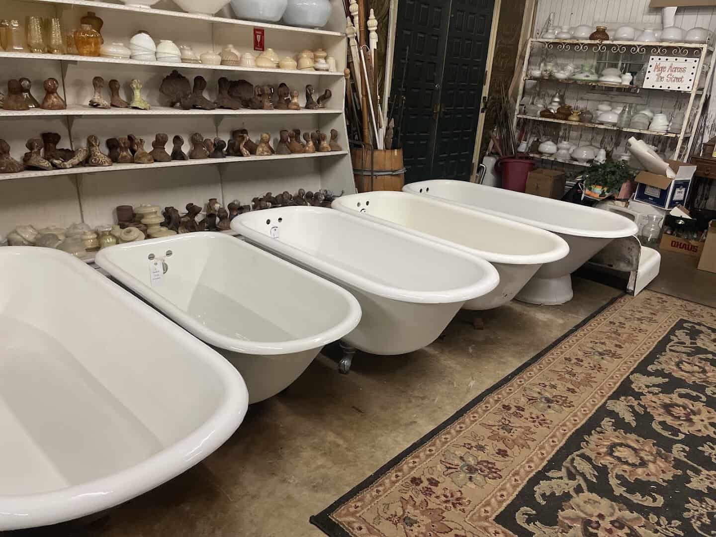 Row of antique clawfoot bathtubs in the tub yard at Old Home Supply House in Fort Worth