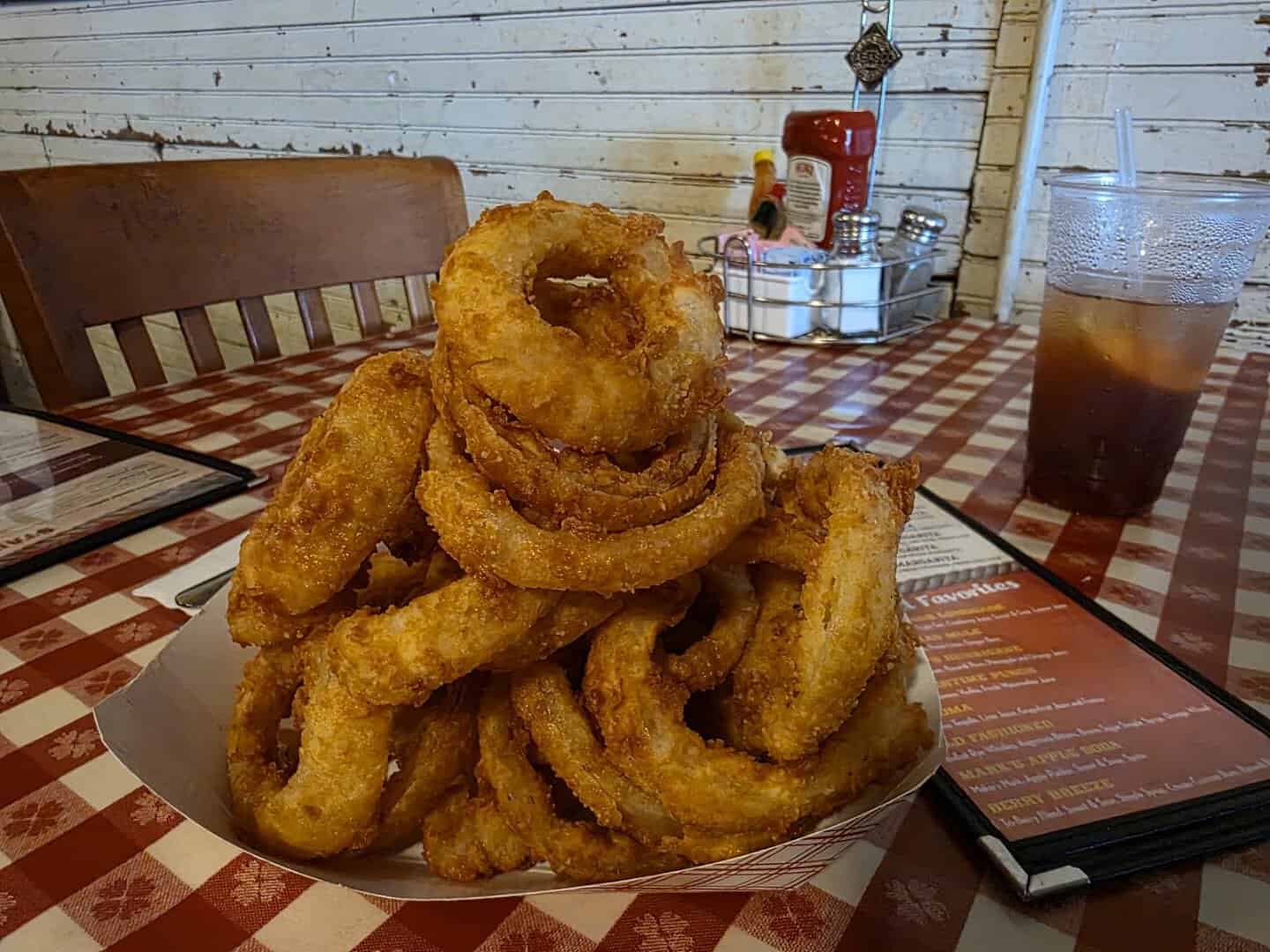 Towering stack of hand breaded onion rings at Clear Springs Restaurant
