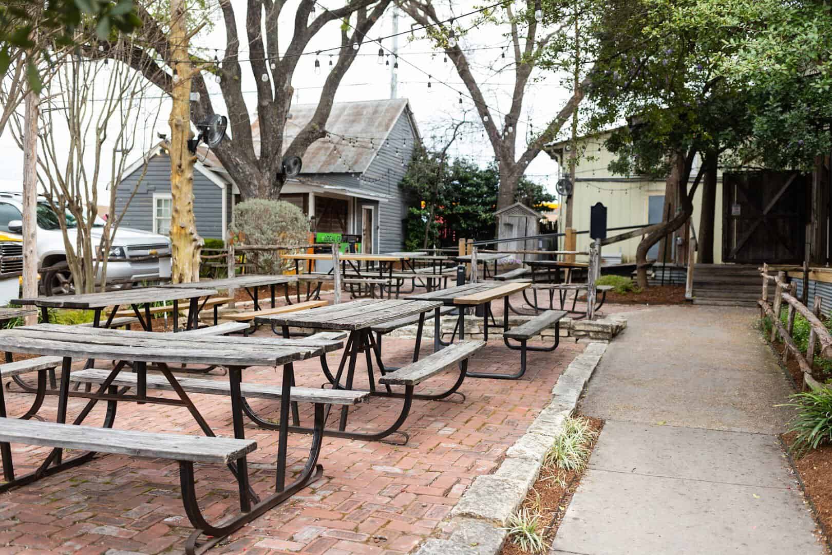 Shaded outdoor picnic tables on the patio at Clear Springs Restaurant