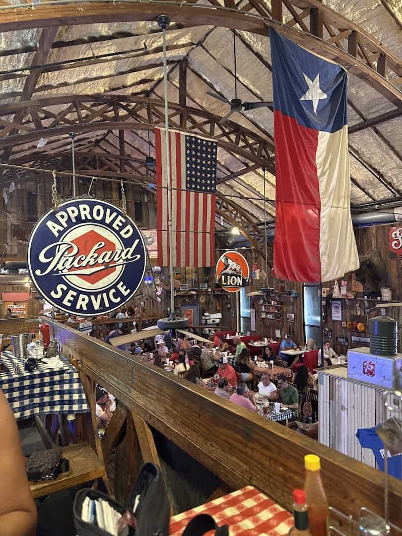 A large Texas flag hanging inside the historic hall at Clear Springs Restaurant