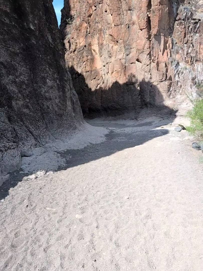 Curving sandy floor of Closed Canyon Trail between tall rock walls, Big Bend Ranch State Park, Texas