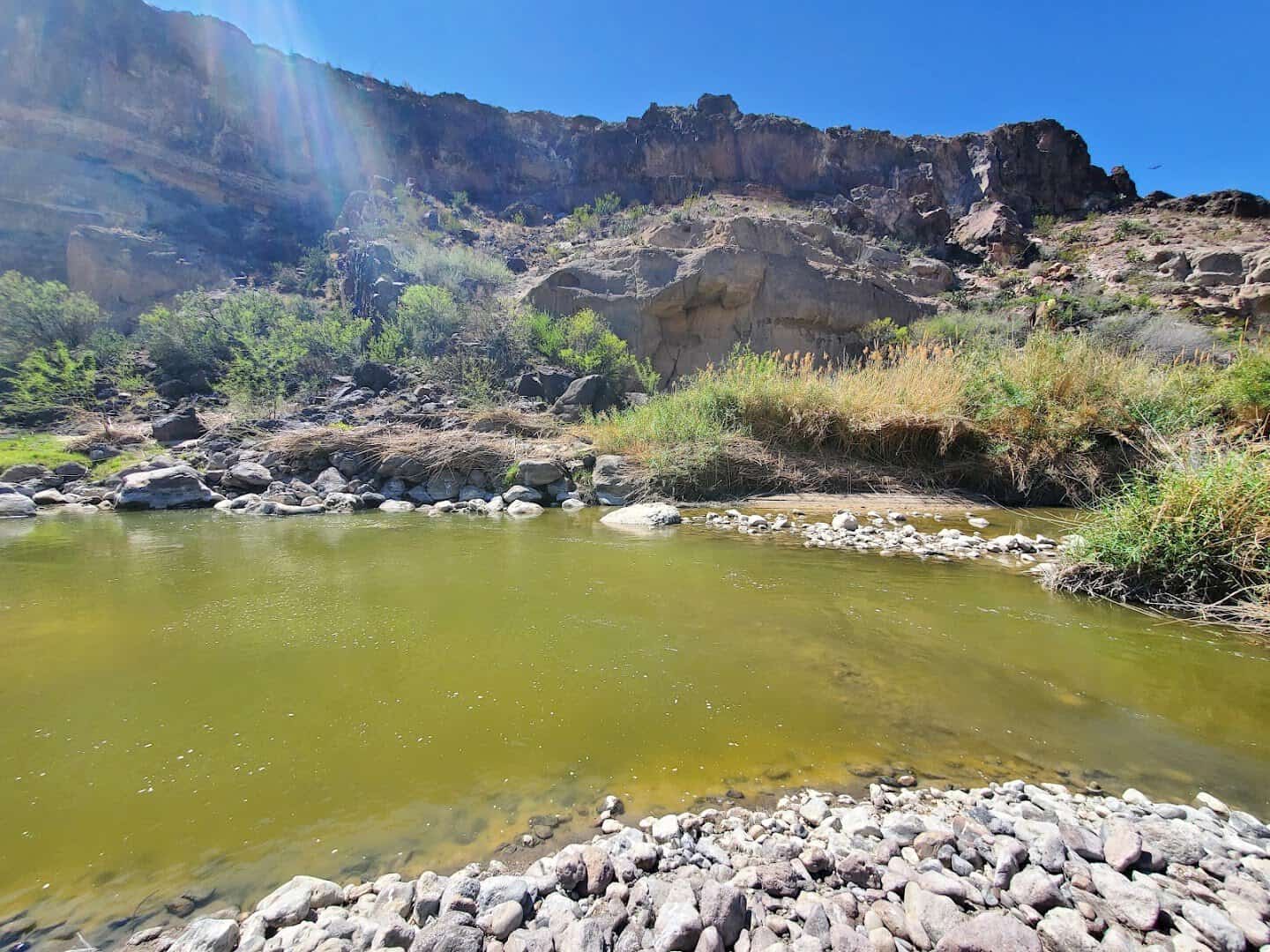 A pool of water at the base of the canyon walls near Closed Canyon, Big Bend Ranch State Park, Texas