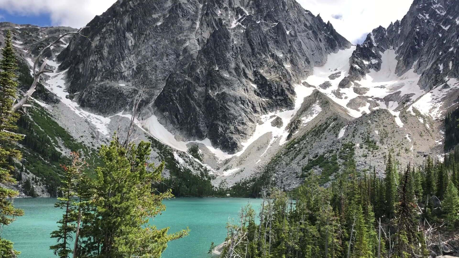 Turquoise Colchuck Lake beneath the granite spires of Dragontail and Colchuck peaks, the Enchantments, Washington