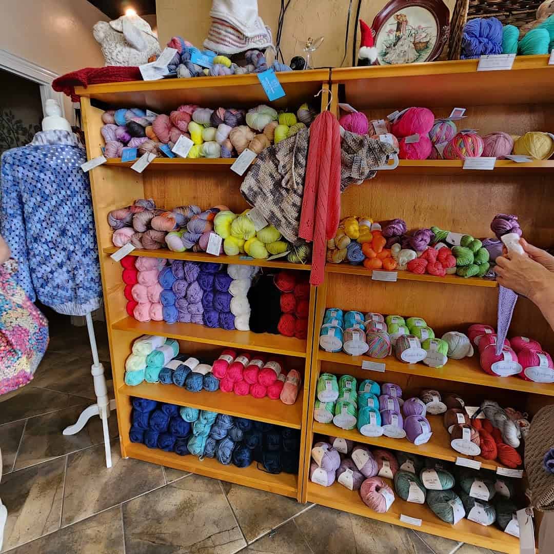 A wall of colorful yarn arranged by color at Lone Star Yarn in Bedford, Texas
