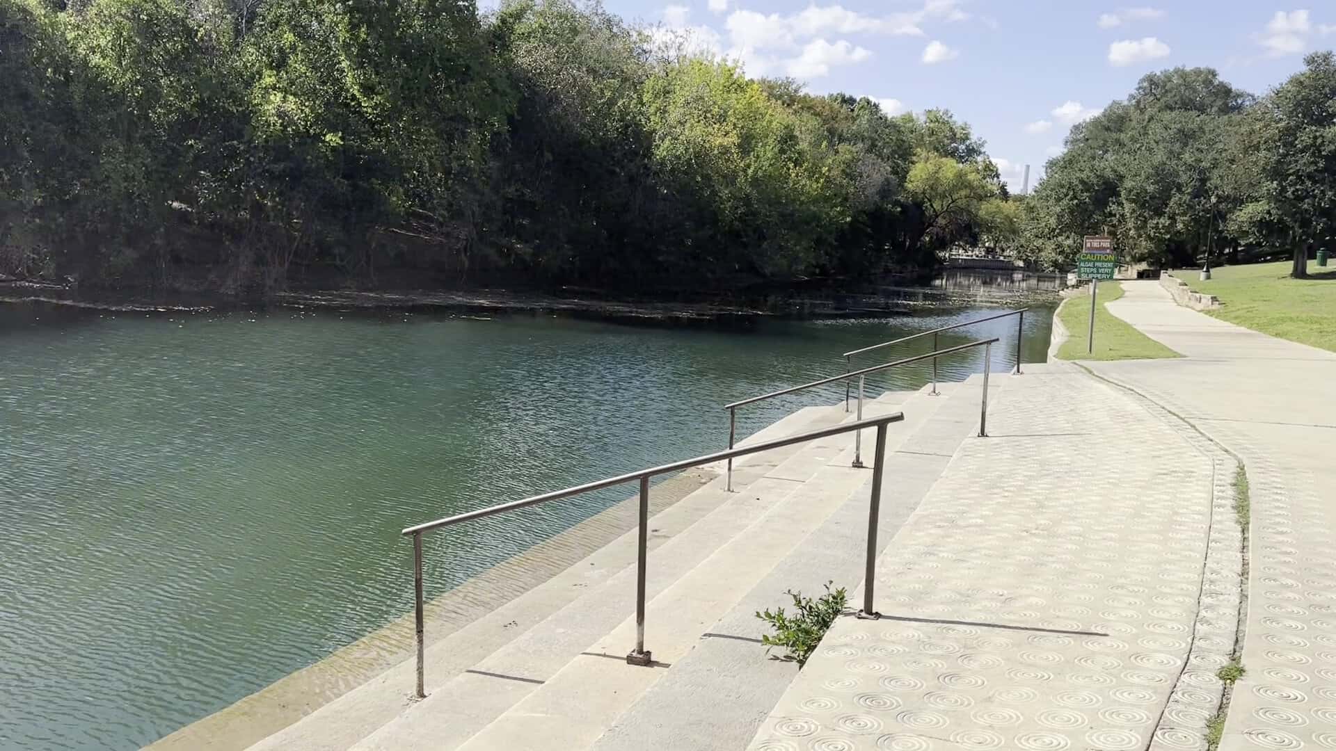 River access steps and handrail leading into the clear Comal River at Hinman Island Park