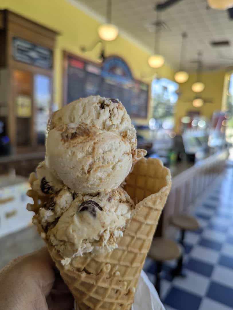 Waffle cone of cookie ice cream with the checkered floor behind it at Beth Marie's in Denton