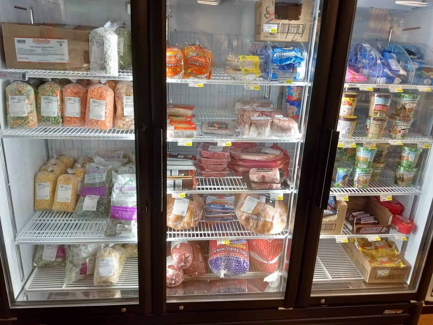Cooler of packaged cheeses and deli meats at Olde Towne Country Store in Itasca Texas