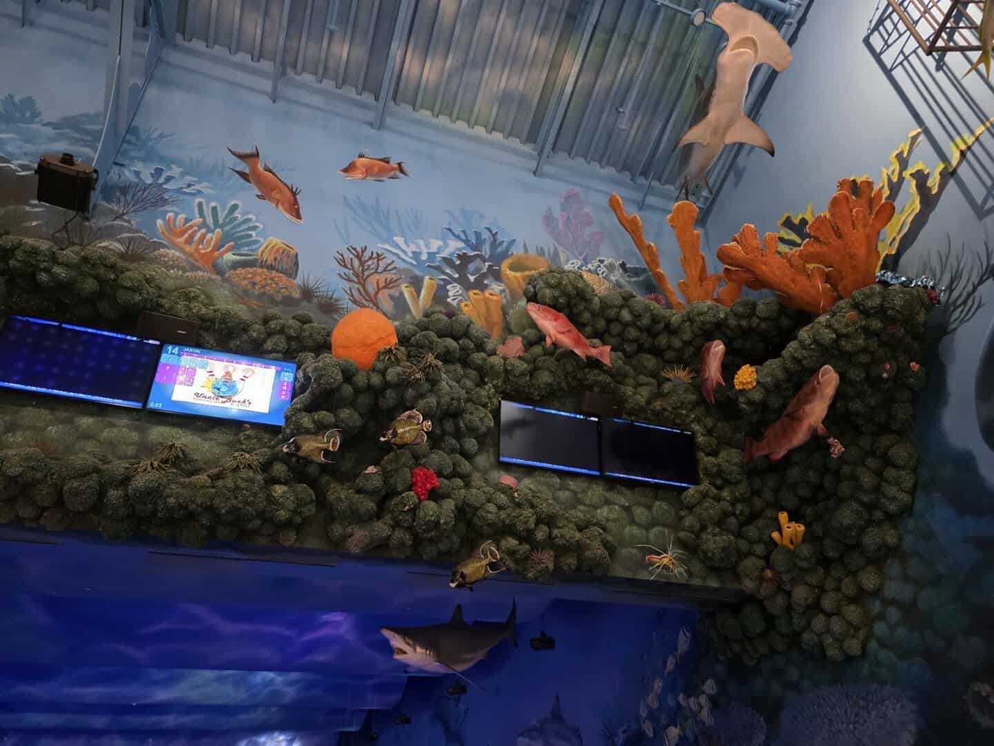 Coral reef decor and a hammerhead shark above the bowling lanes at Uncle Buck's Fishbowl and Grill in Round Rock