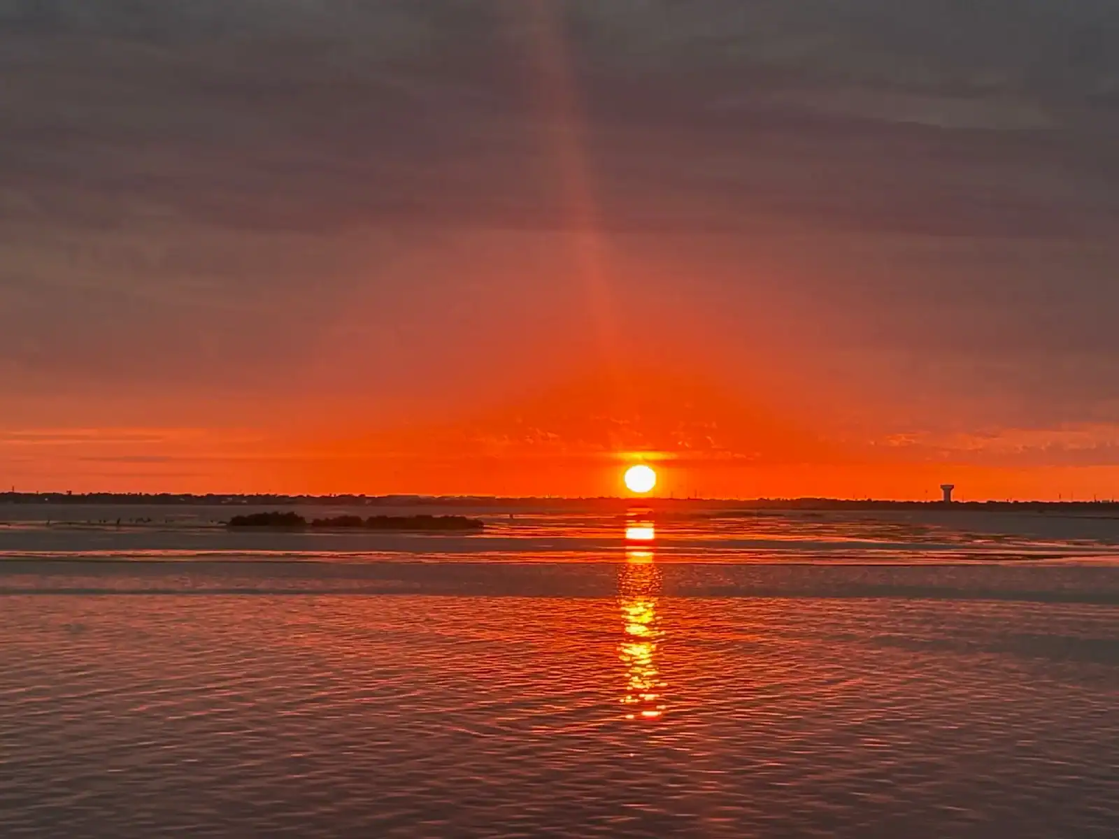 Sunset over the water at Snoopy's Pier in Corpus Christi
