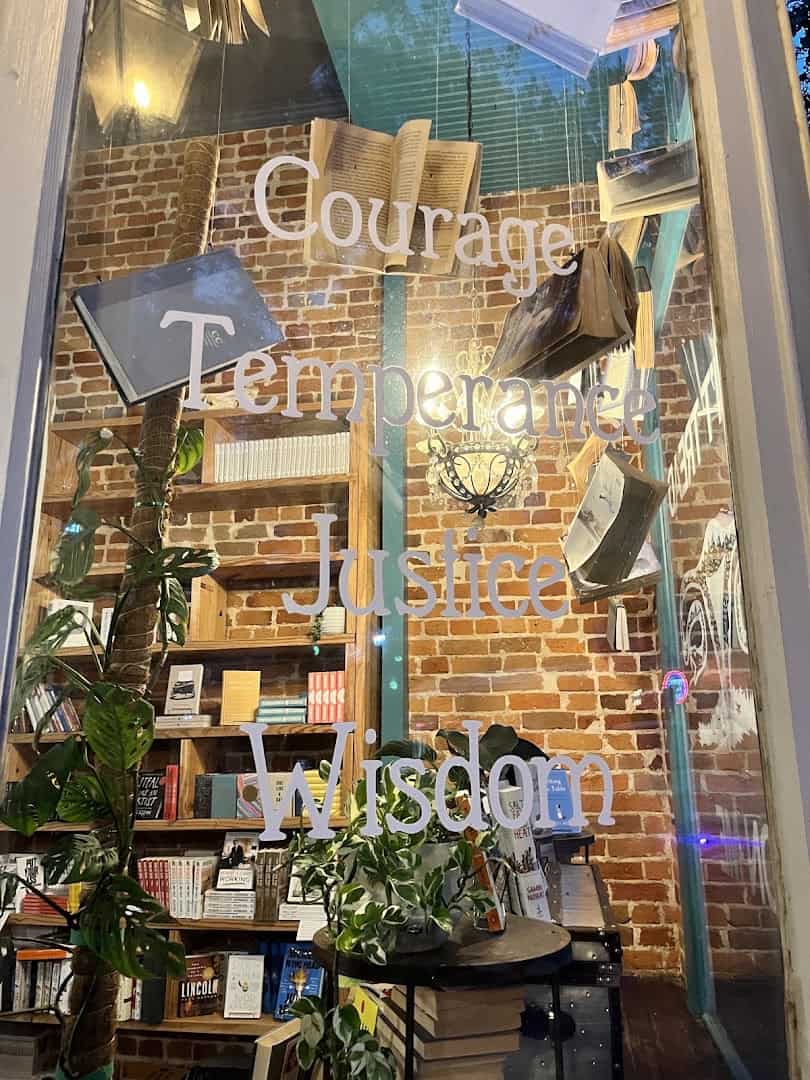 Front window painted with Courage, Temperance, Justice and Wisdom at The Painted Porch Bookshop in Bastrop, Texas