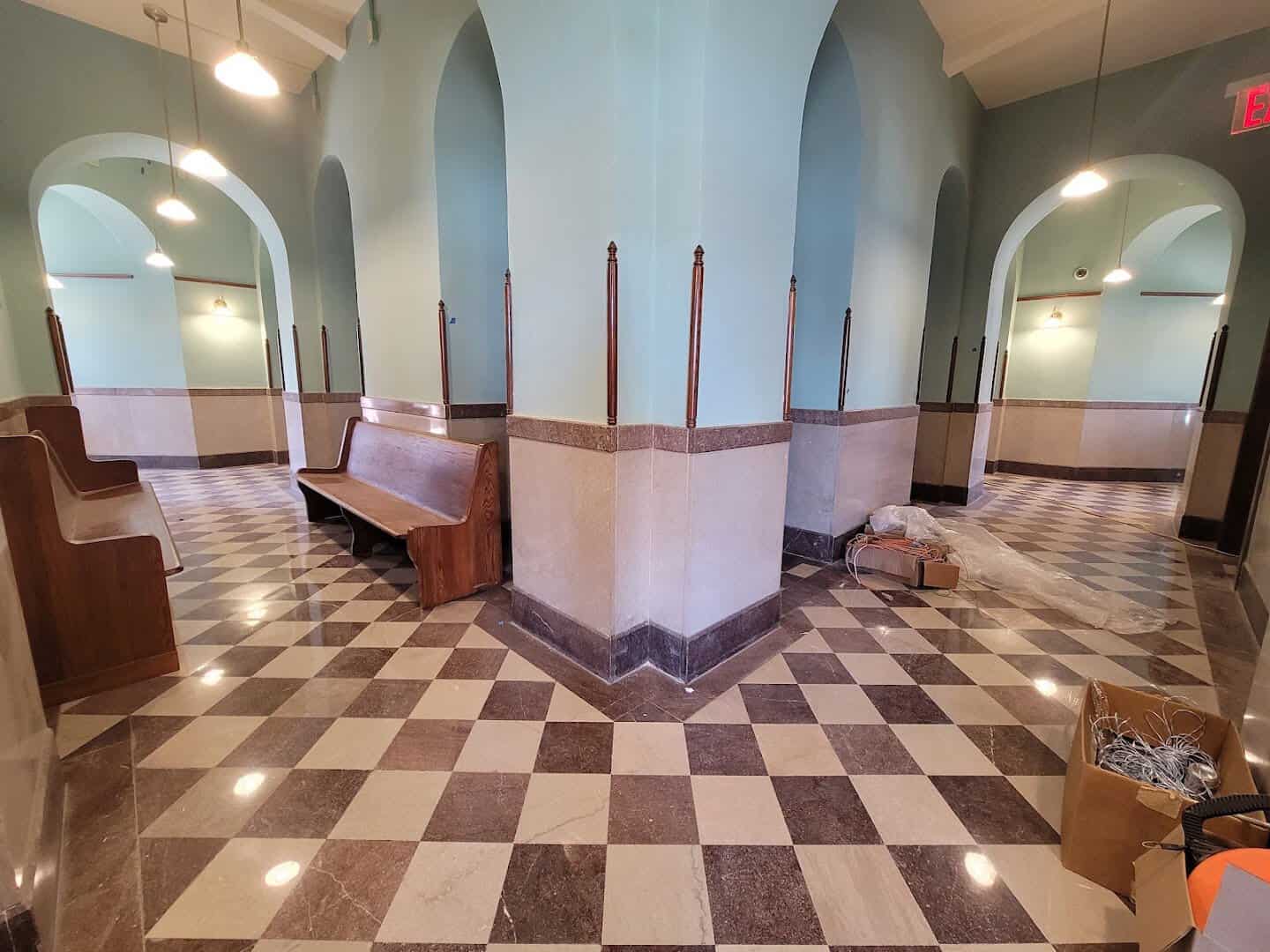 Marble arches and a checkerboard floor inside the restored courthouse