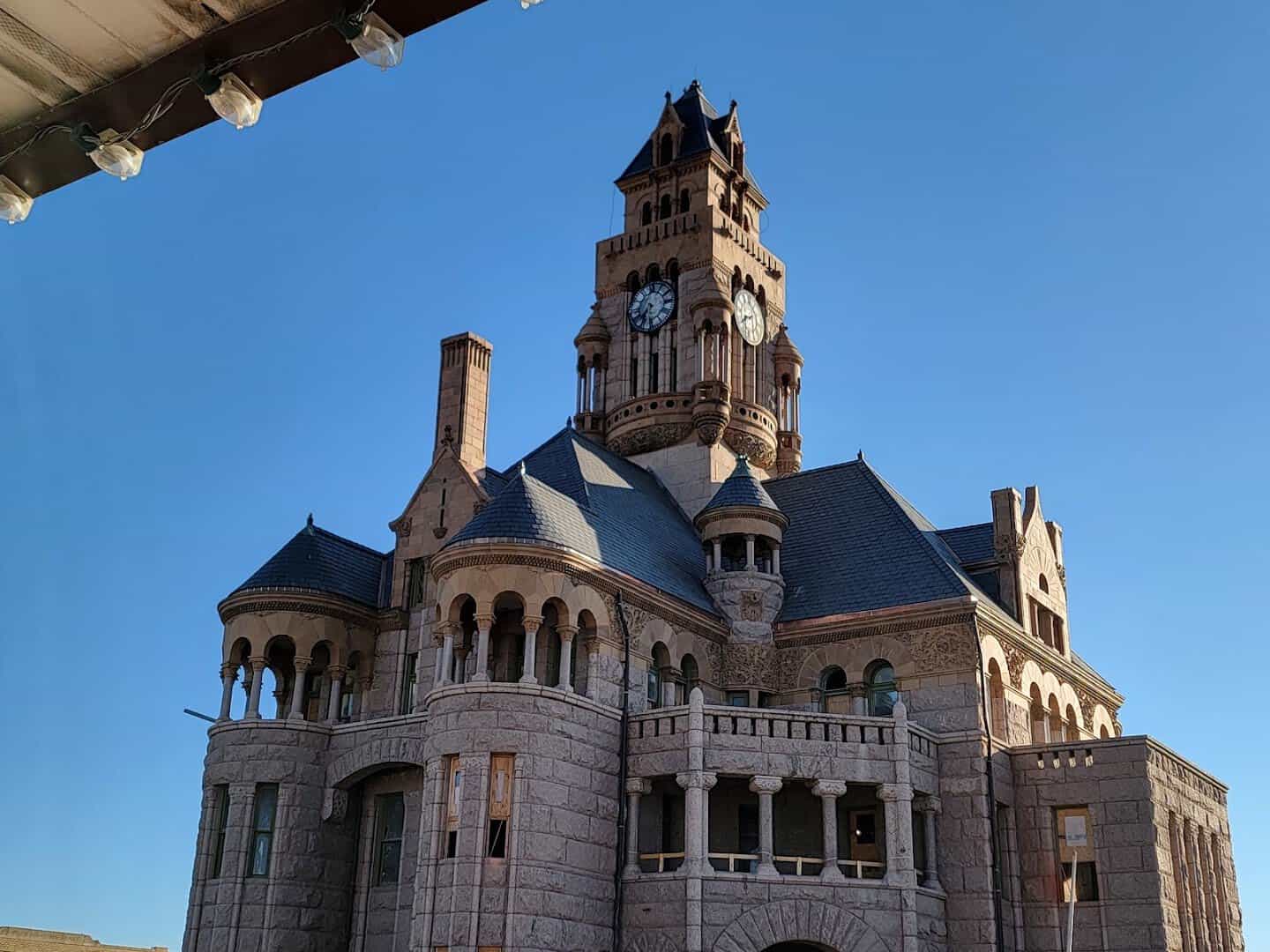 The courthouse tower framed by a stone arch