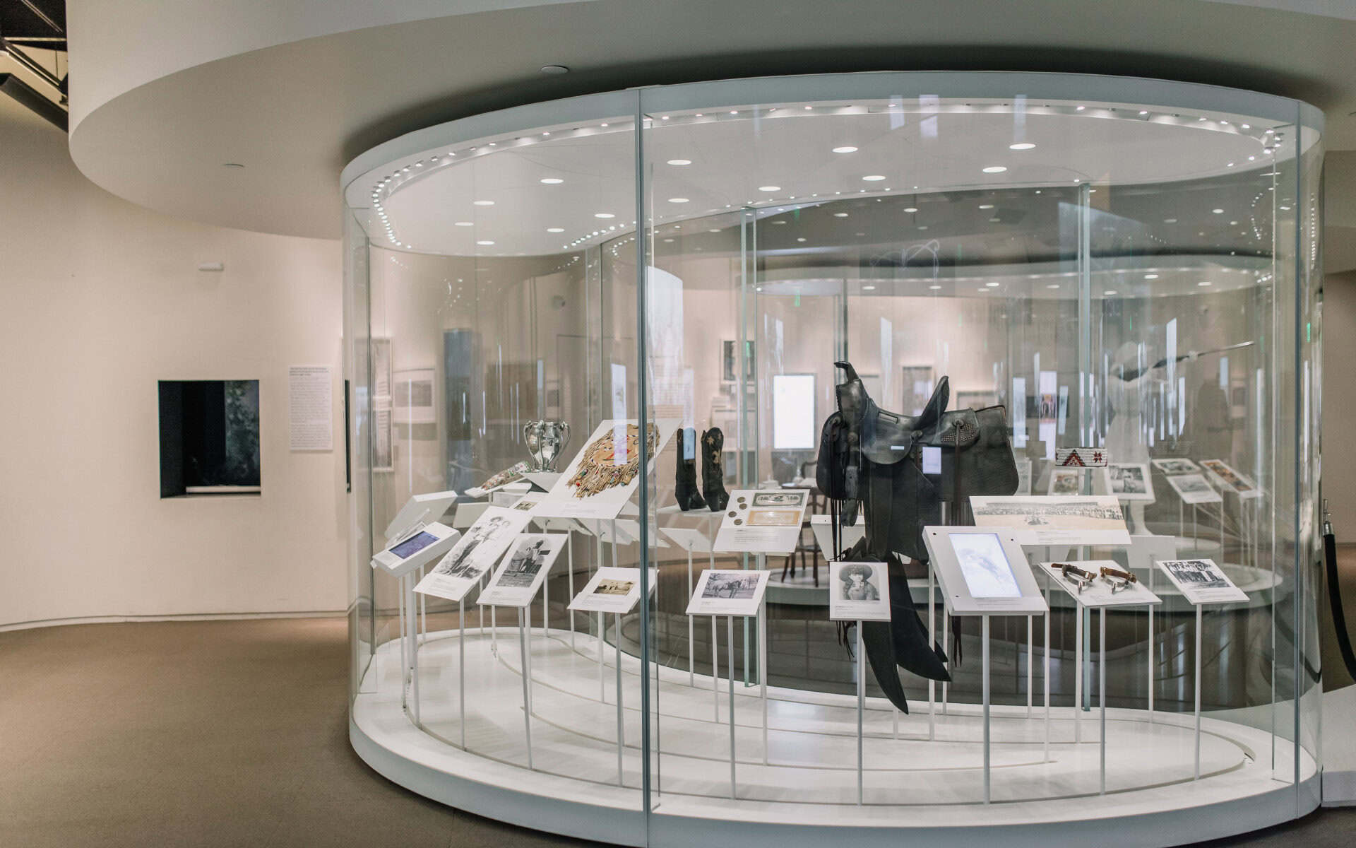 Glass display case of saddles, boots and trophies at the National Cowgirl Museum in Fort Worth