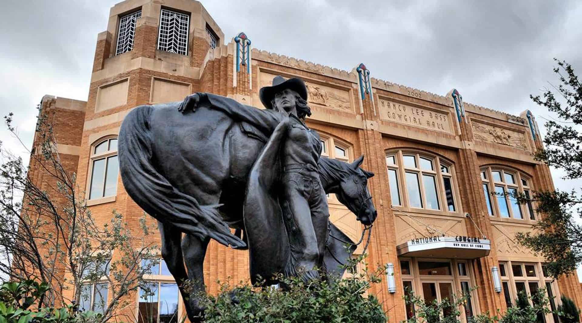 Bronze cowgirl statue outside the National Cowgirl Museum and Hall of Fame building in Fort Worth, Texas