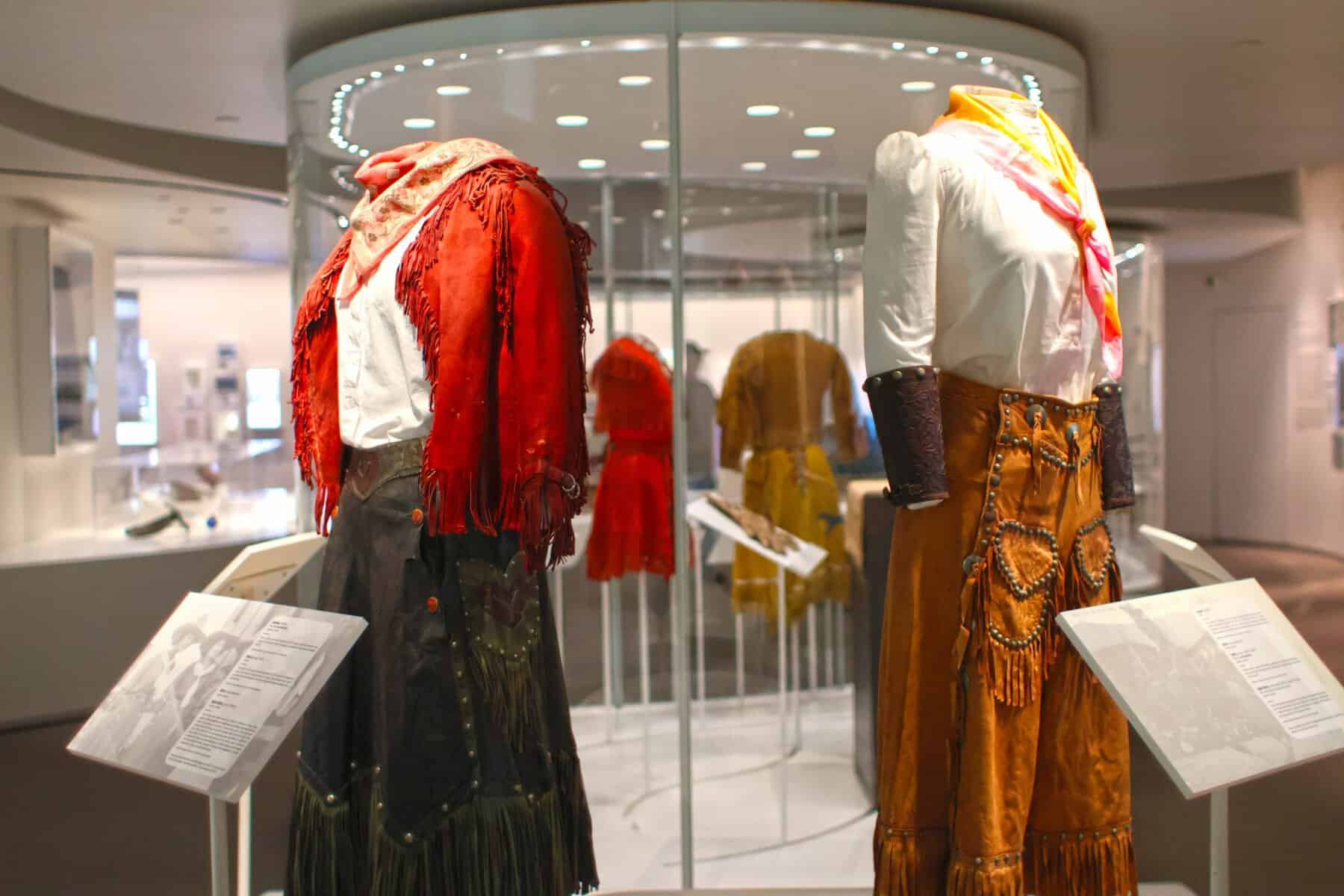 Vintage fringed cowgirl outfits on display at the National Cowgirl Museum in Fort Worth