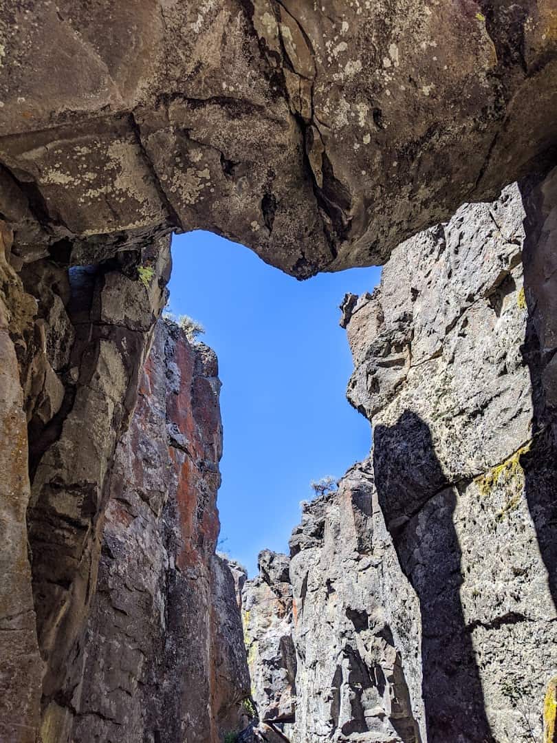 A keyhole of sky between the tall rock walls of Crack in the Ground near Christmas Valley, Oregon
