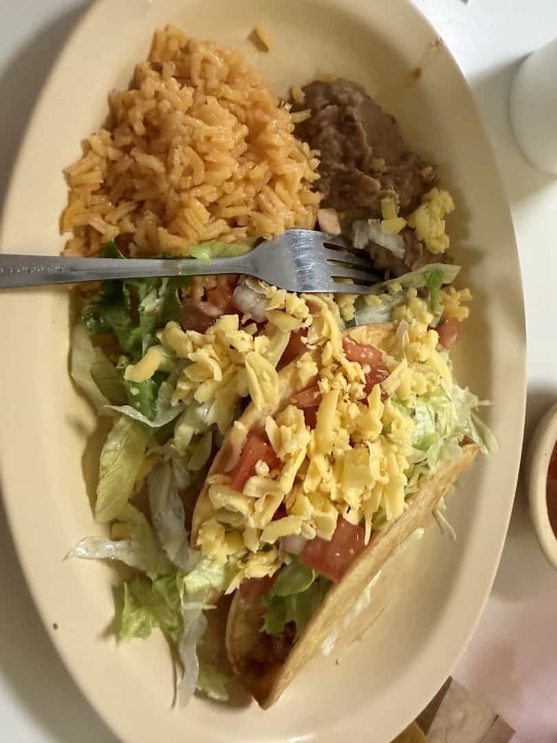Crispy taco and enchilada plate with rice and beans at Southside Barbacoa in Corpus Christi