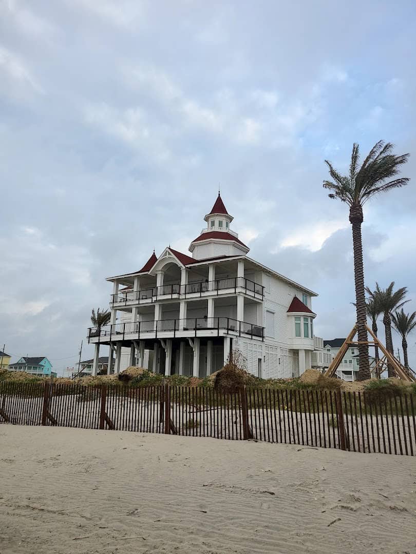 Sand and dune fence in front of a stilt beach house at Crystal Beach on the Bolivar Peninsula, Texas