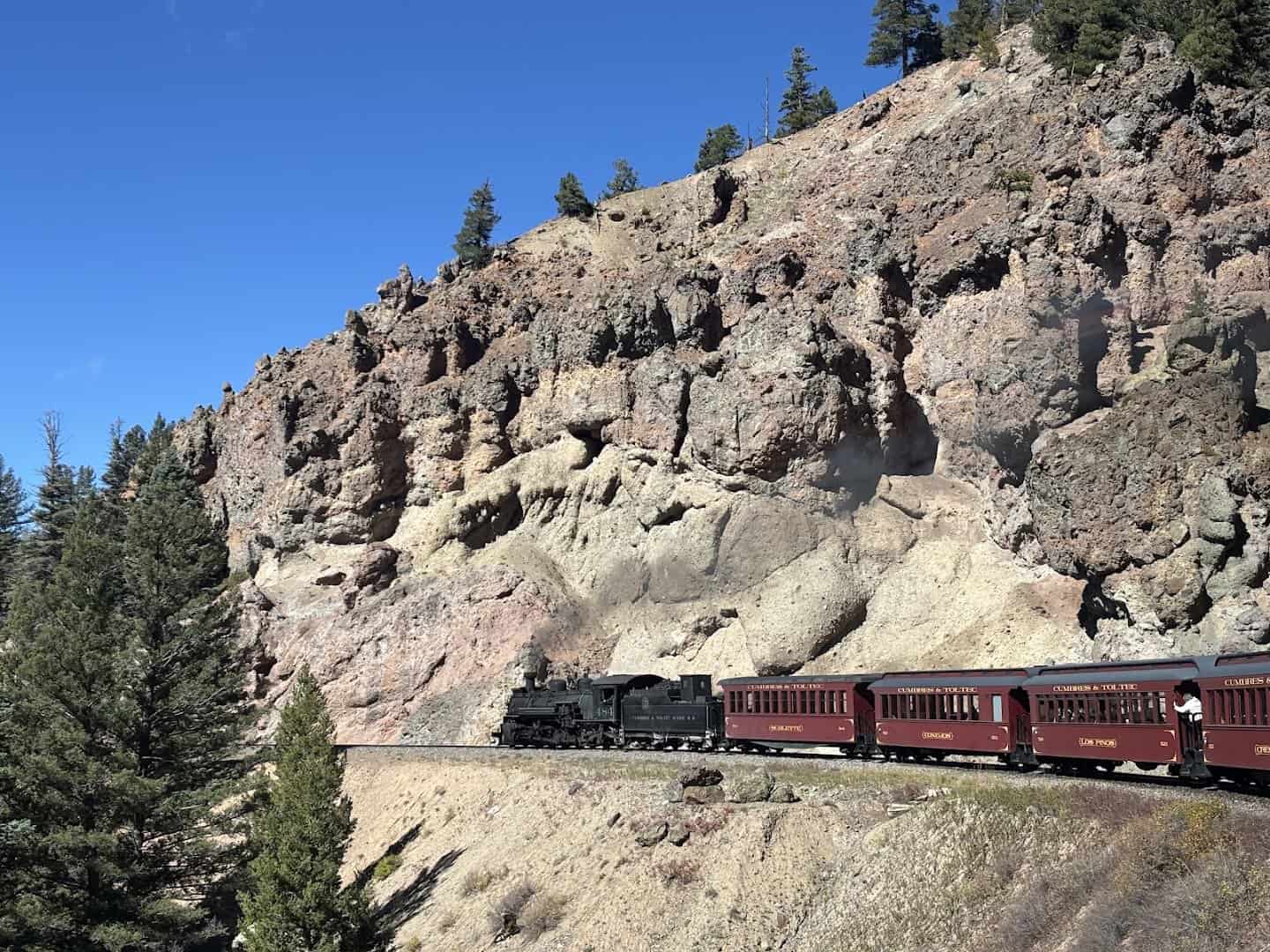 Cumbres and Toltec Scenic Railroad train winding along a rocky mountainside, New Mexico