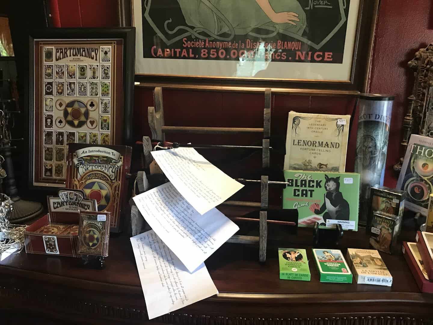 Display case of antique curiosities and books at Curia Arcanum in Austin, Texas