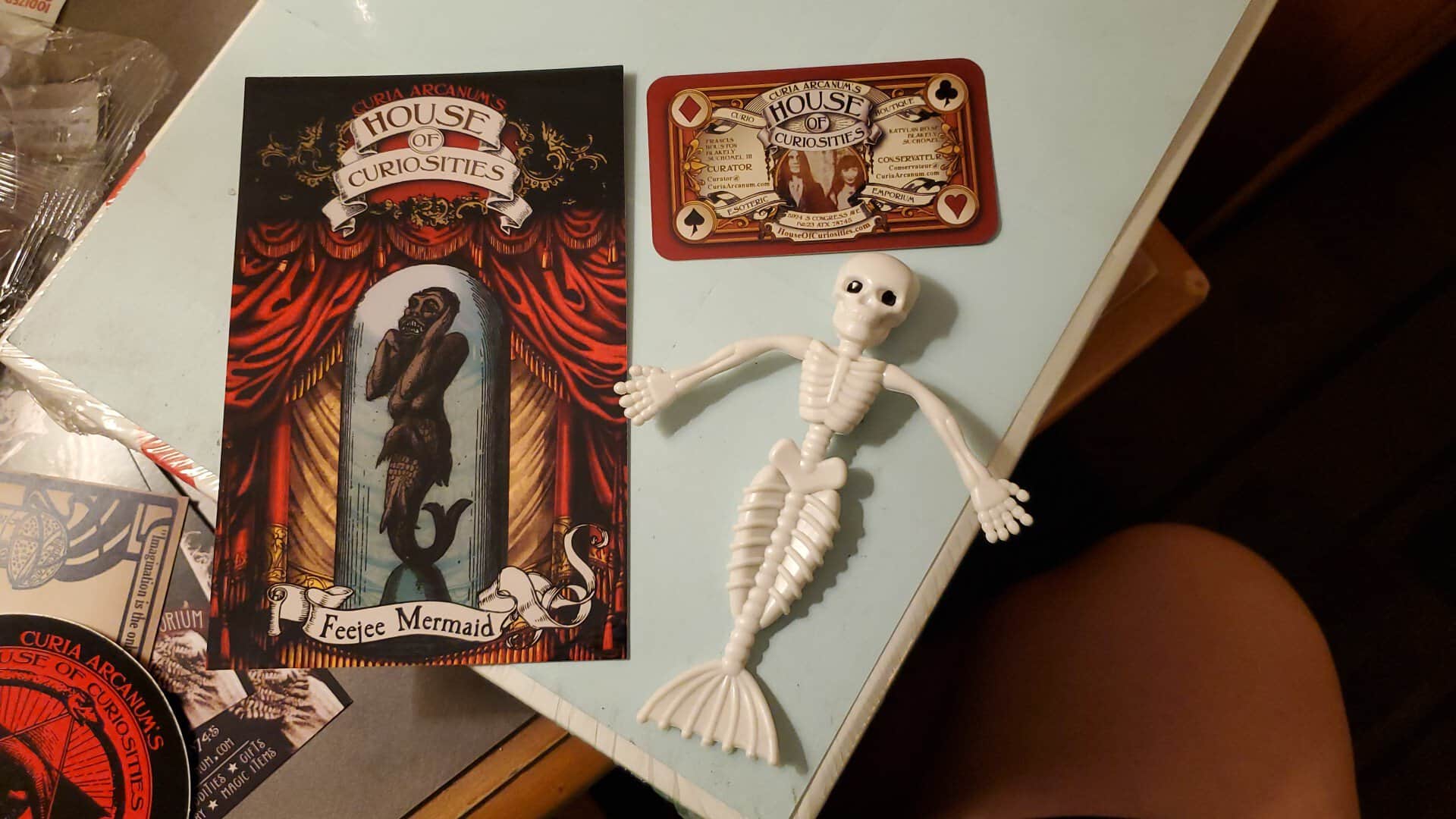 Framed art and a handmade curiosity at Curia Arcanum's House of Curiosities in Austin, Texas