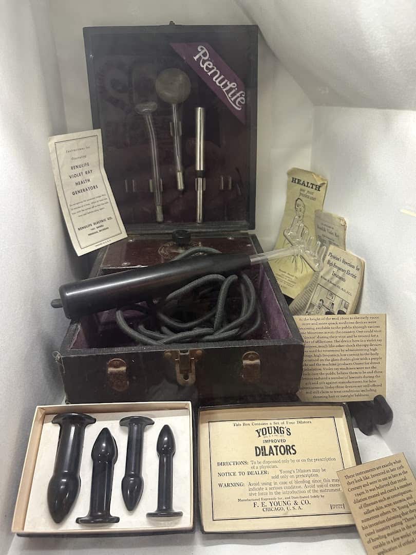 Case of antique instruments and curiosities at Curia Arcanum in Austin, Texas