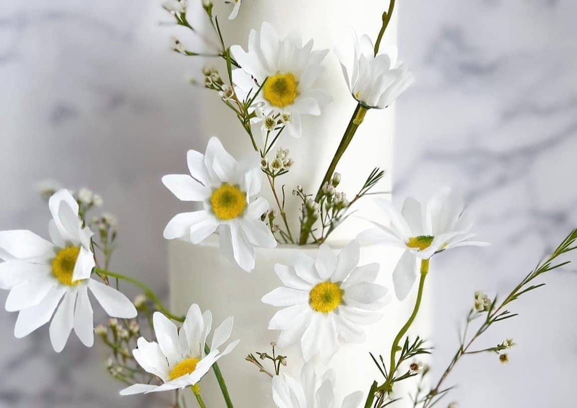 Gluten-free cake decorated with daisies at Sweet Gilly's in Frisco