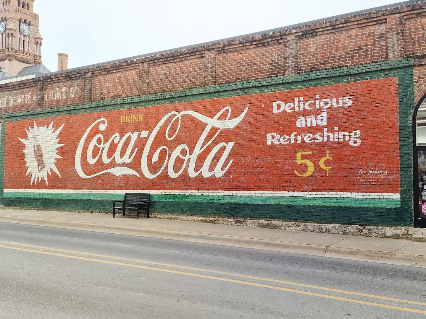 A vintage painted Coca-Cola mural on a brick wall in downtown Decatur, Texas