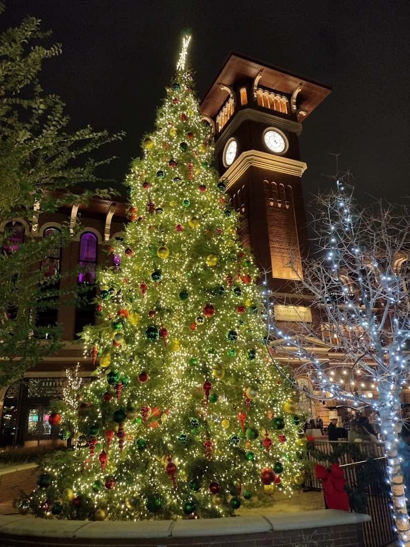 Giant lit and ornamented Christmas tree in front of the Main Street clock tower in Grapevine, Texas