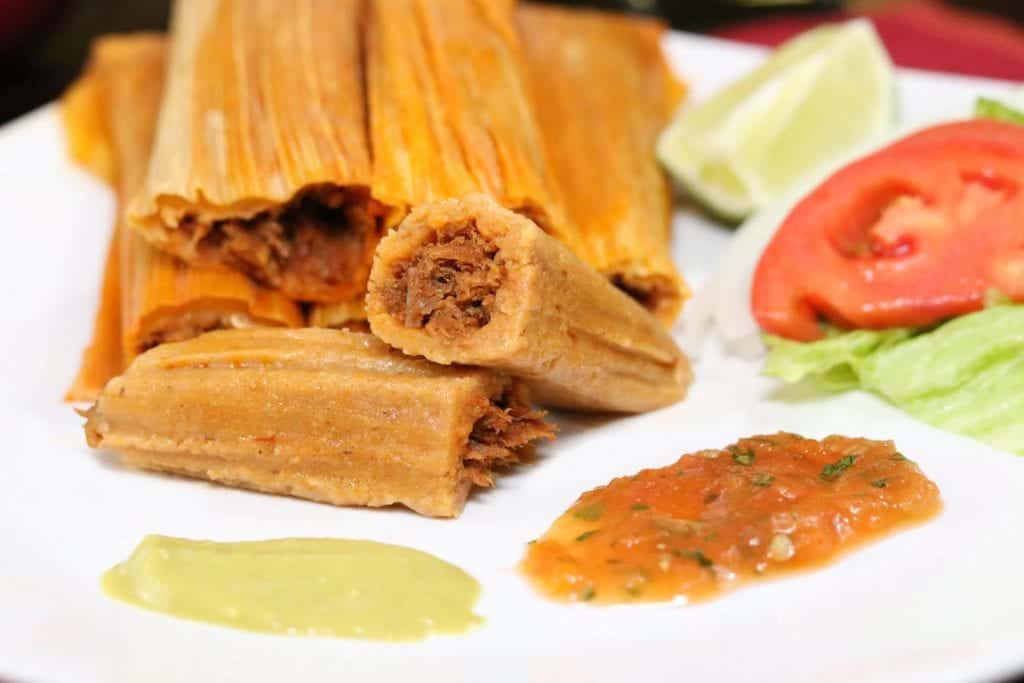 Pork tamales with salsa and lime at Delia's Tamales in McAllen, Texas