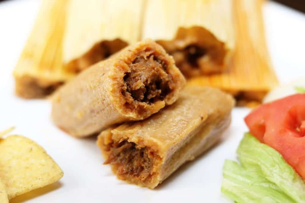 Stacked pork tamales showing the filling at Delia's Tamales in McAllen, Texas
