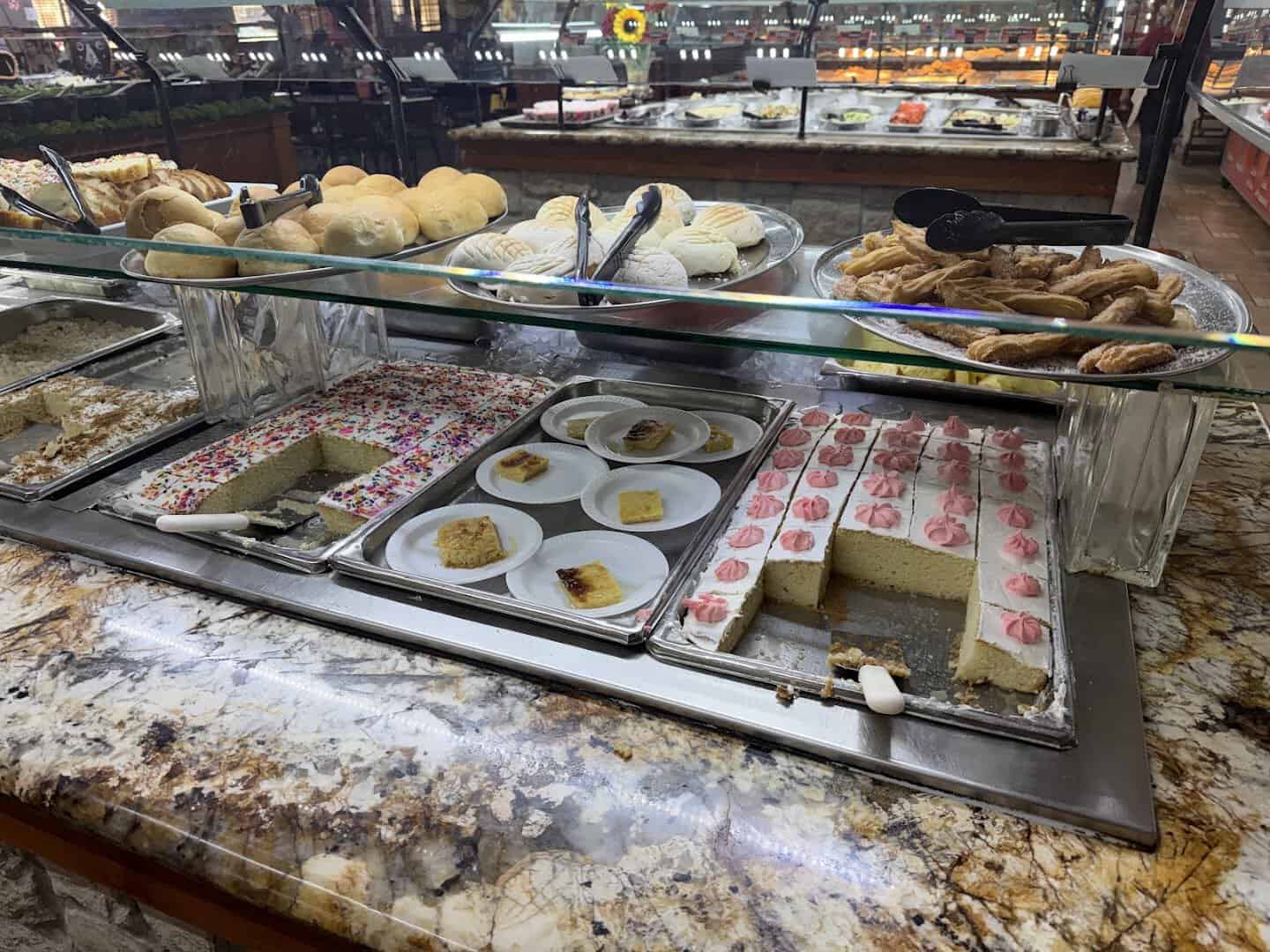 Dessert line with tres leches cake, sweet bread and churros at Ranchero King Buffet in Houston