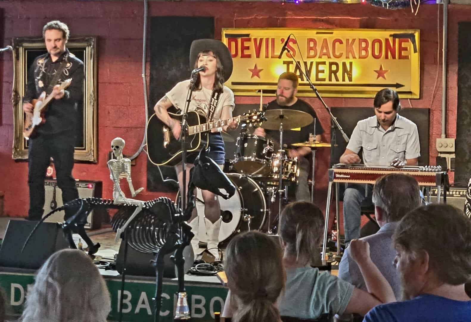 A band performing live music on stage at Devil's Backbone Tavern in Fischer, Texas