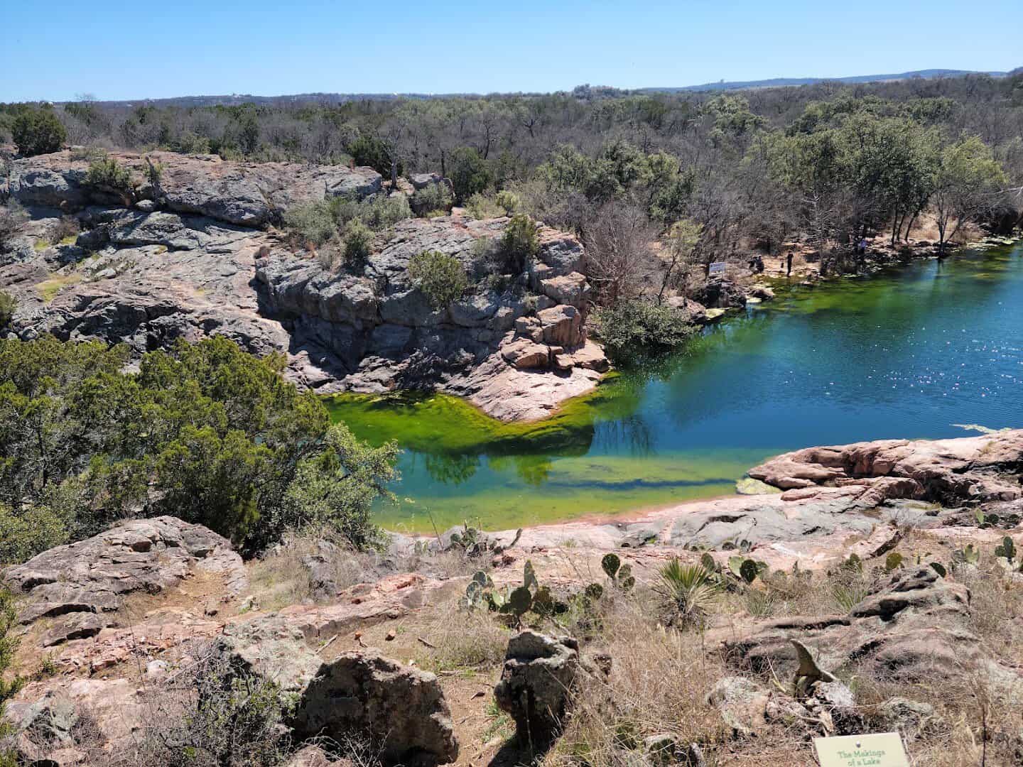 Pink granite boulders ringing the pool at Devil's Waterhole, Inks Lake State Park, Texas
