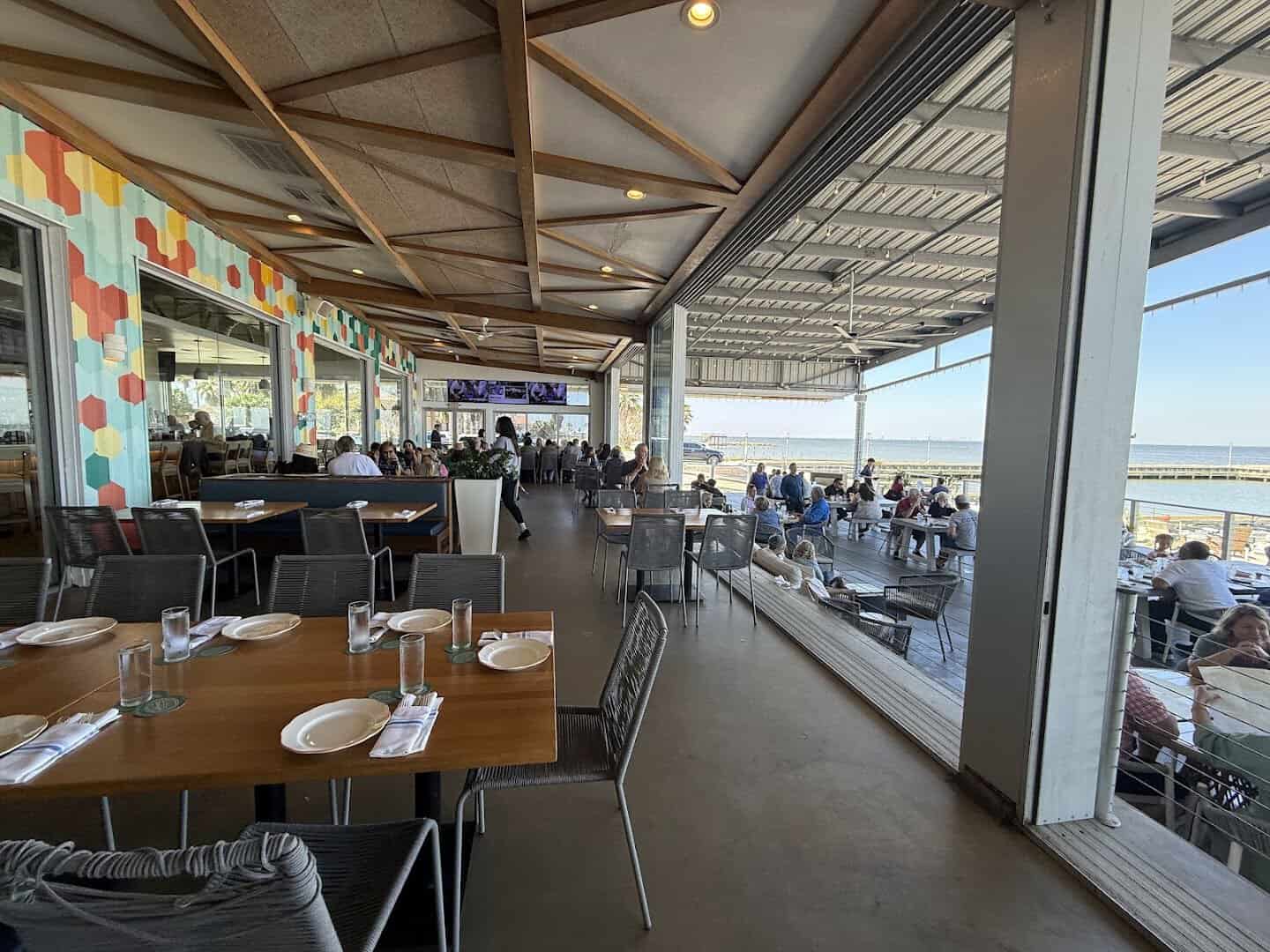 Dining room with floor to ceiling windows overlooking Galveston Bay at Pier 6 in San Leon, Texas