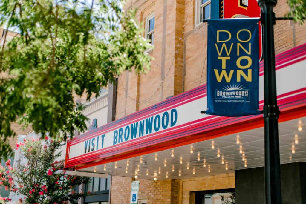 Downtown Brownwood, Texas with a Visit Brownwood banner and string lights