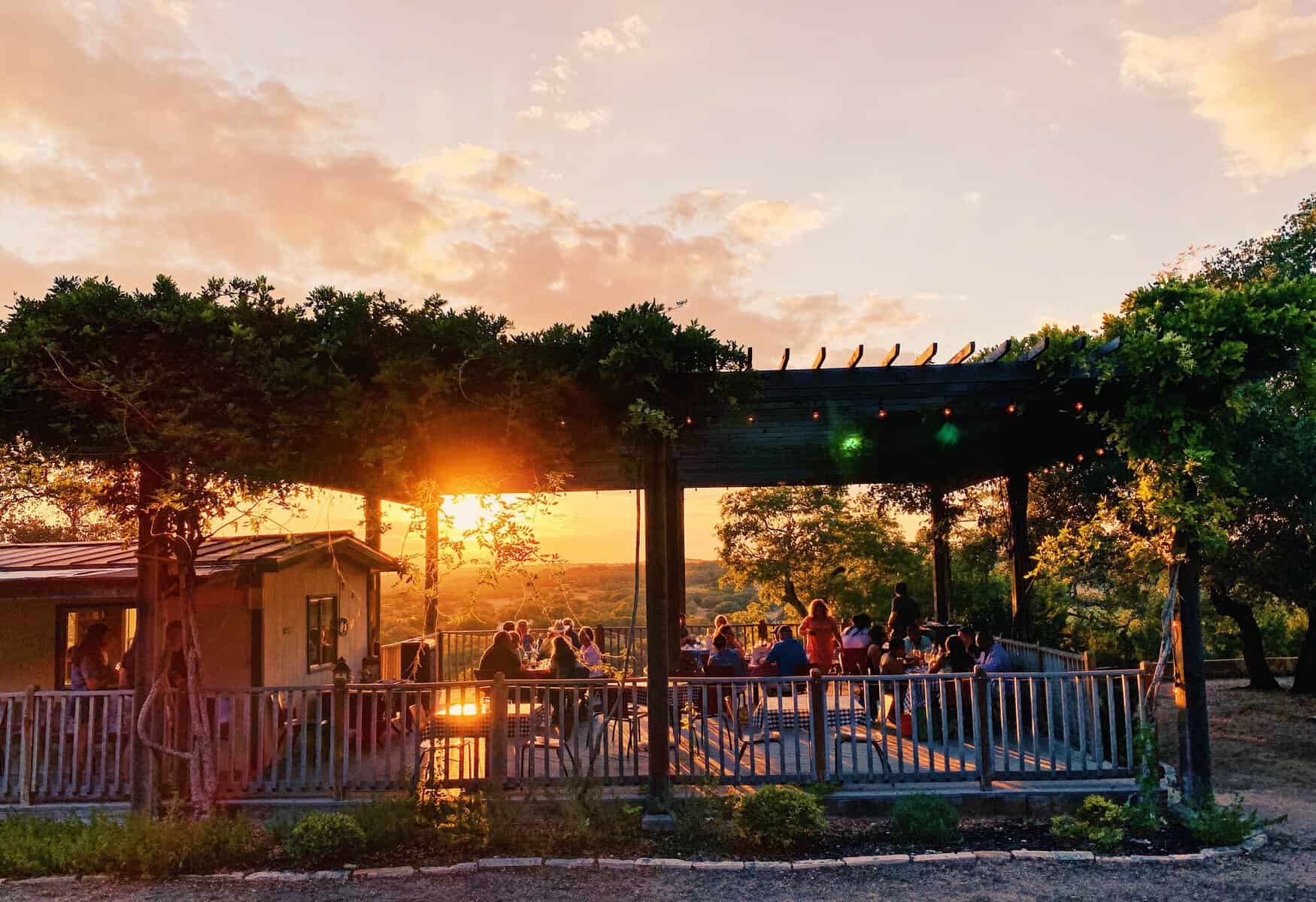 Sunset over the vineyard deck at Driftwood Estate Winery in Driftwood, Texas