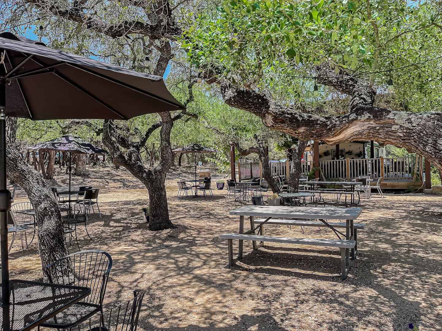 An oak-shaded patio and cabin with a Hill Country view near Driftwood, Texas