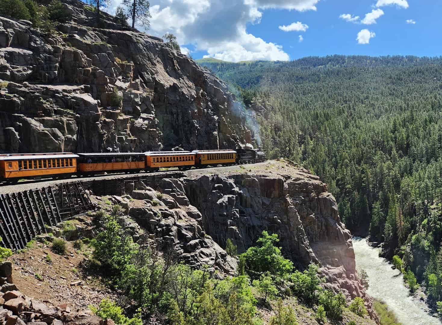 Durango and Silverton narrow gauge train on a cliff shelf above the Animas River canyon, Colorado