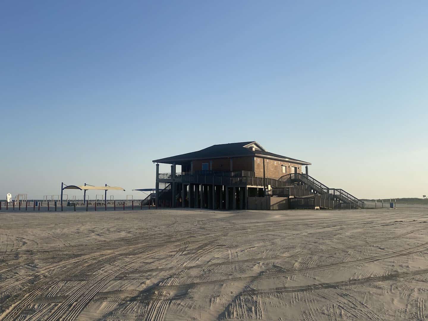 Beach pavilion on the wide sand at East Beach in Galveston, Texas