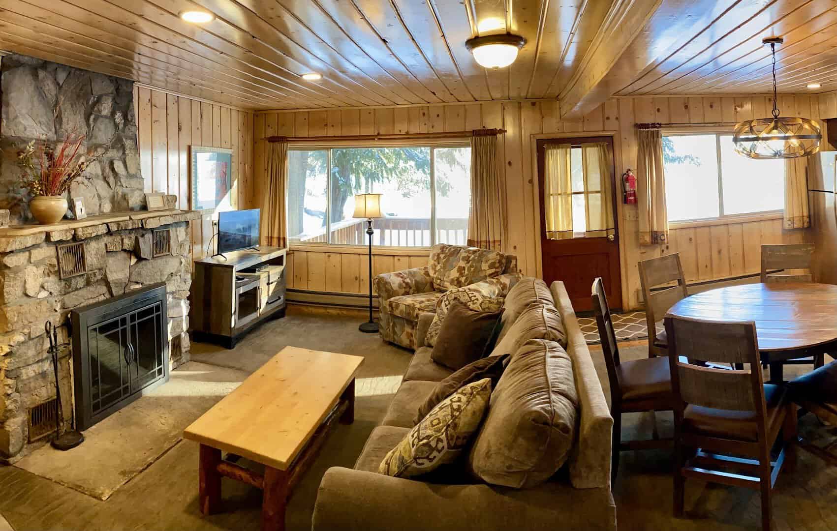 Cozy cabin living room with a stone fireplace, Elkins Resort on Priest Lake, Idaho