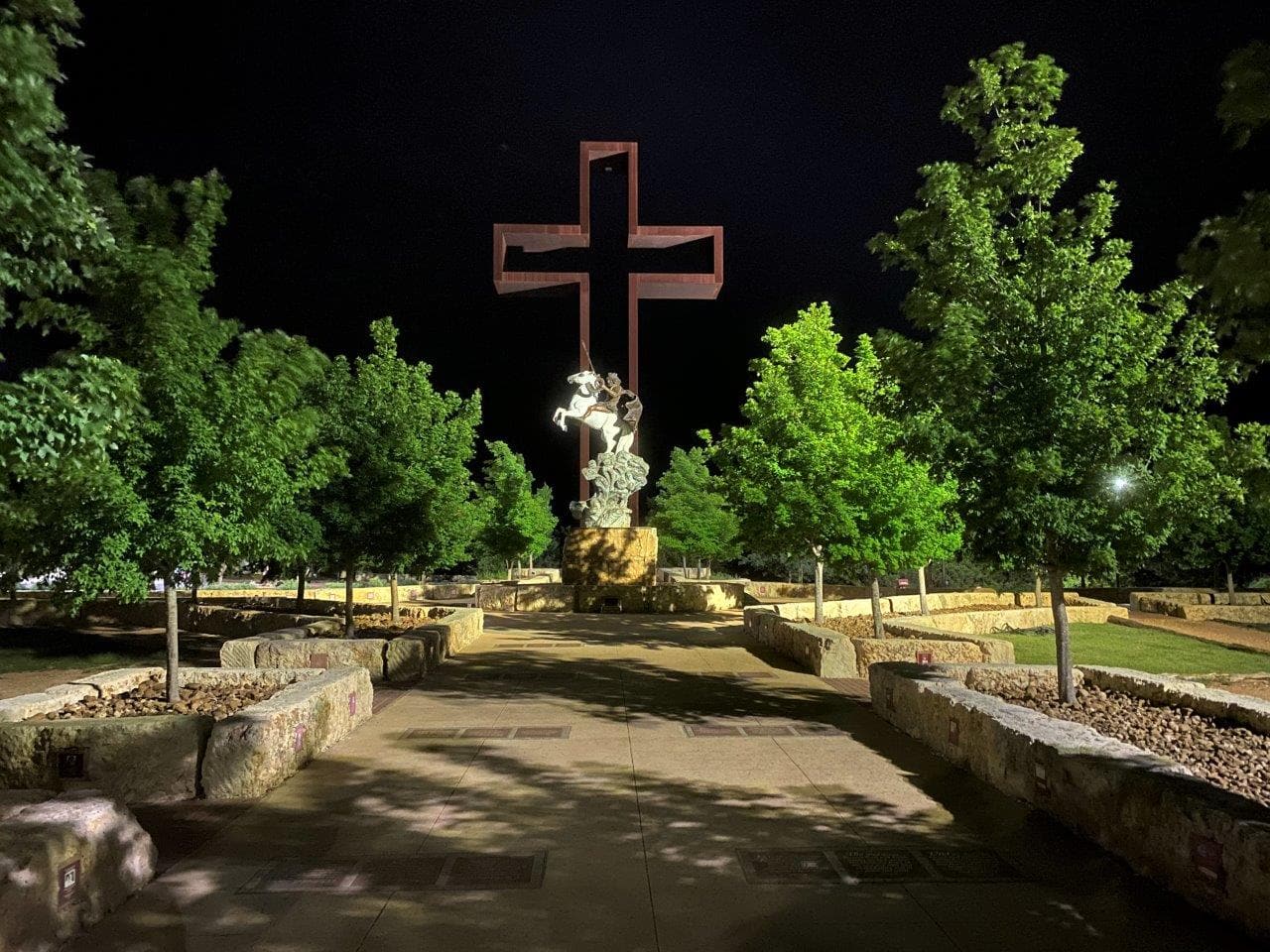 The Empty Cross lit at night at the Coming King Sculpture Prayer Garden in Kerrville