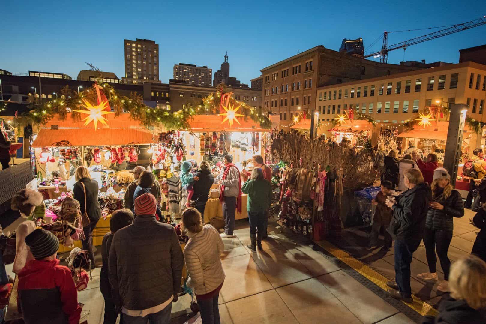 Lit Christmas market huts with glowing star lanterns at Union Depot, St. Paul, Minnesota