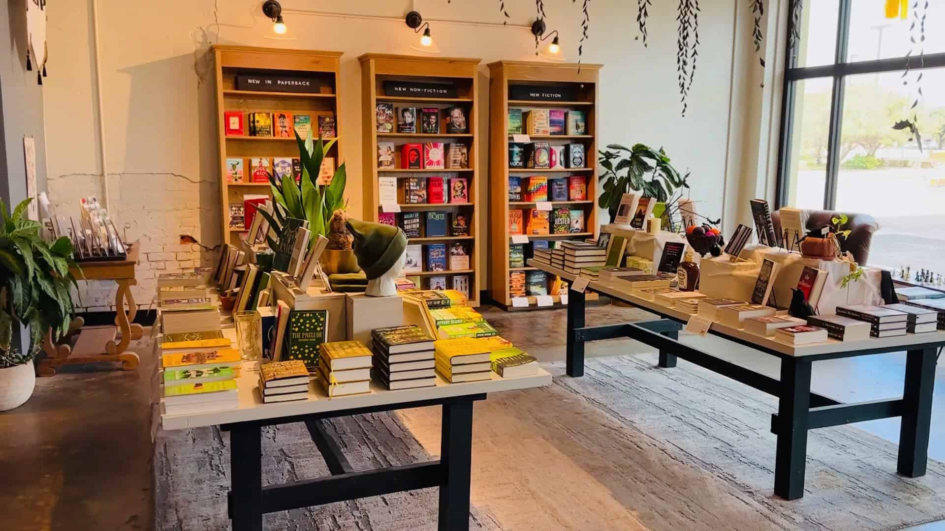 Book display tables and shelves inside Fabled Bookshop and Cafe in Waco